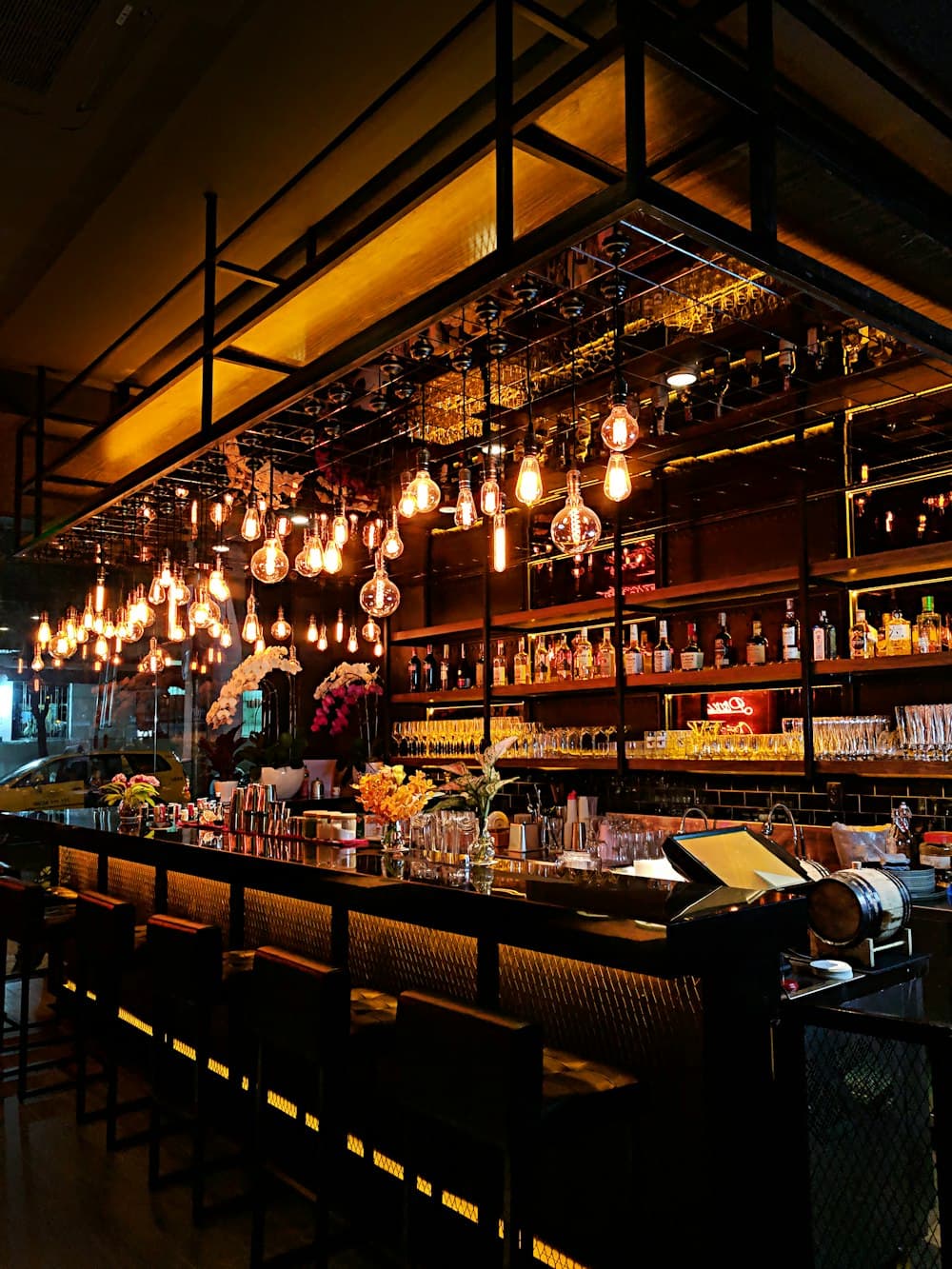 A wood bar with brass beer taps